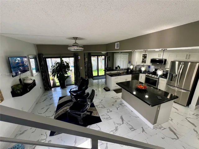 a kitchen with a sink a counter and workspace