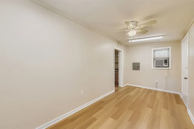 a view of a big room with wooden floor and closet in a room