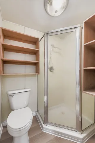 a white house covered with tall trees