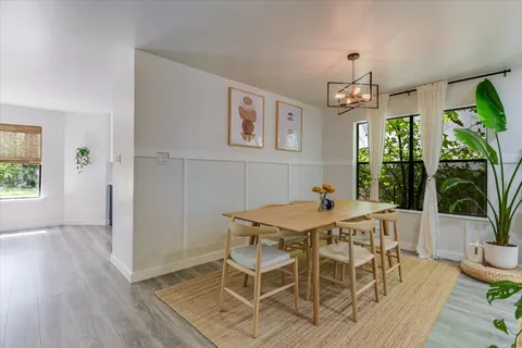 a view of a dining room with furniture window and wooden floor