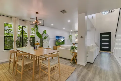 a view of a dining room with furniture and a window