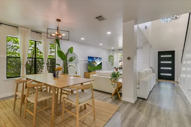 a view of a dining room with furniture and a window
