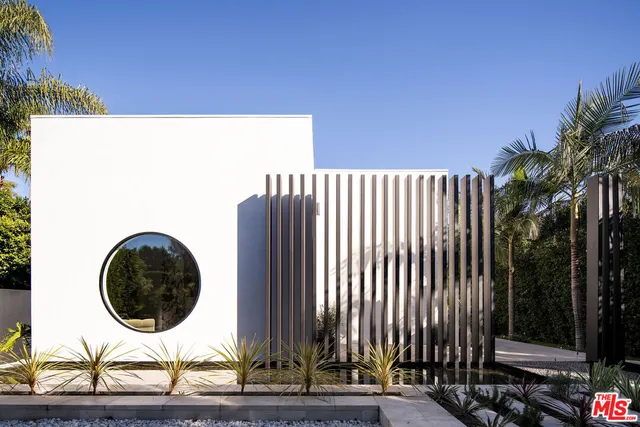 a couple of potted plants sitting in front of a building