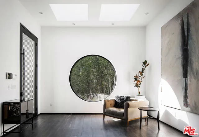 an outdoor living room with furniture and a window