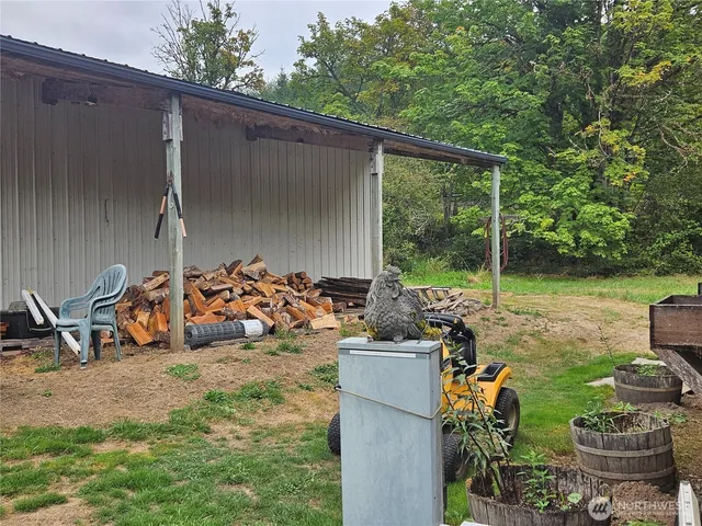 a view of a patio with chairs and potted plants