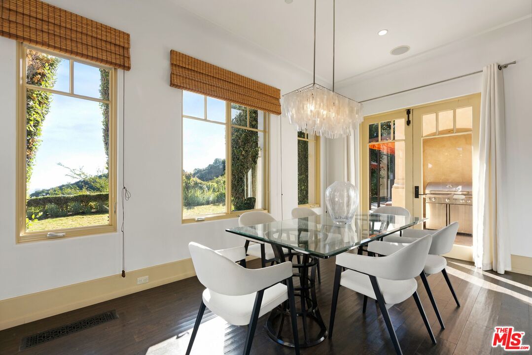 8 Beverly Ridge Terrace Beverly Hills, CA 90210 - Photo 22 of 74 a dining room with furniture large windows and a chandelier