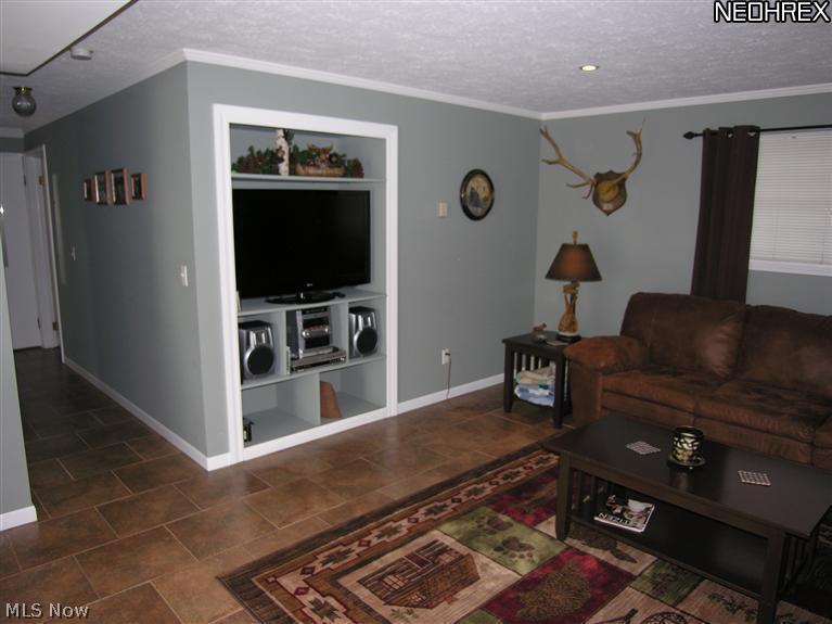 10267 Murray Ridge Road Elyria, OH 44035 - Photo 9 of 25 Family room with ceramic tile floors. Built-ins.
