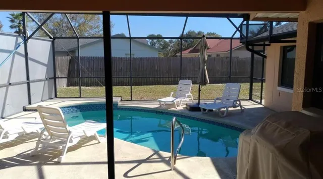 a living room with a glass top table and chairs