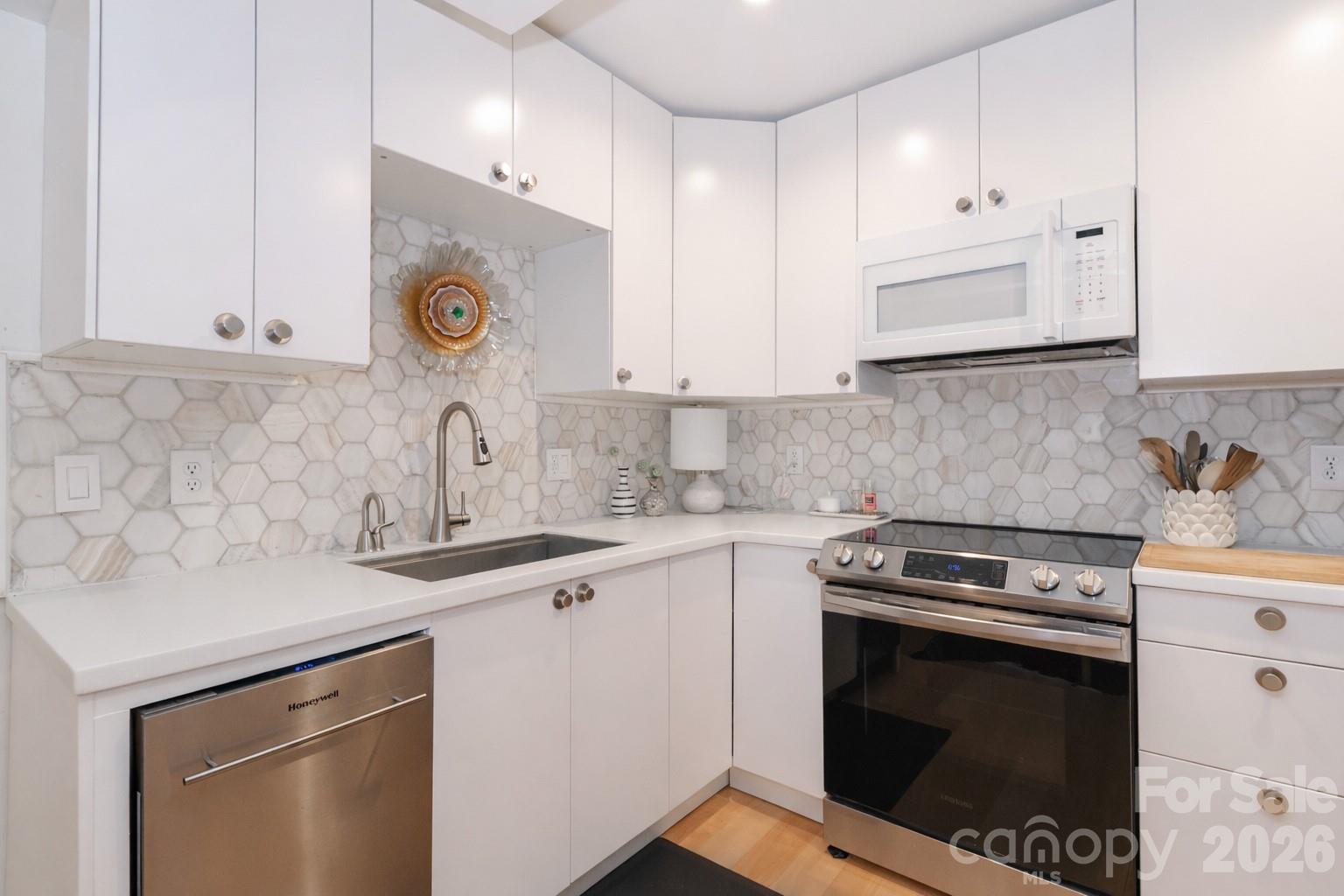 6622 Thermal Road Charlotte, NC 28211 - Photo 11 of 36 a kitchen with a sink stove and cabinets