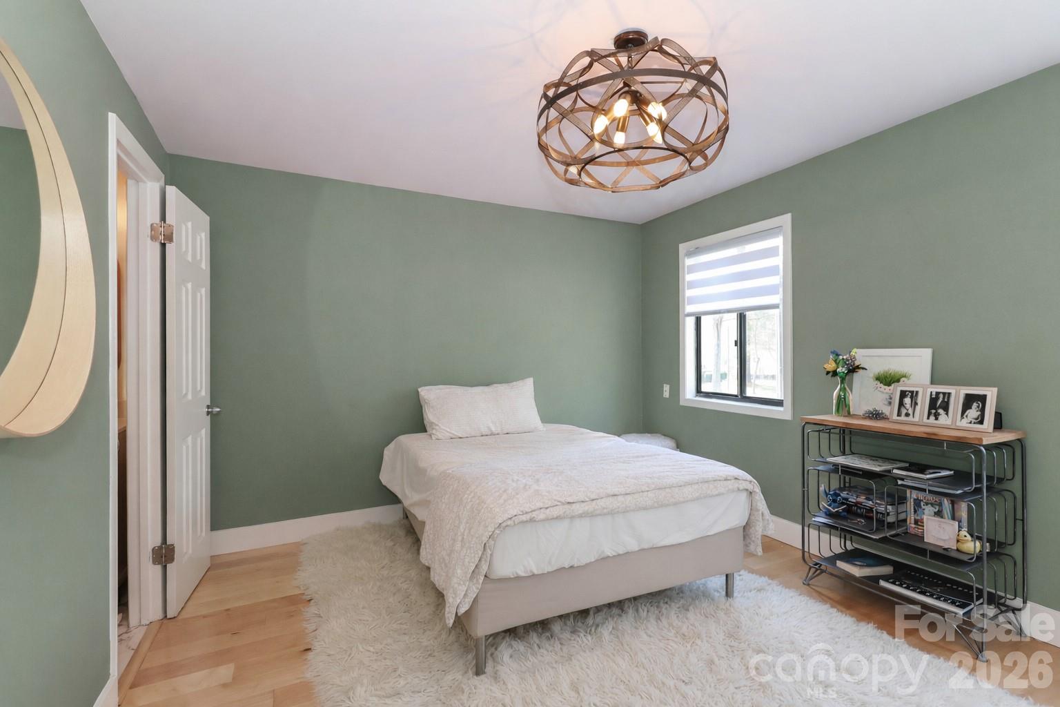6622 Thermal Road Charlotte, NC 28211 - Photo 26 of 36 a bedroom with a bed and a chandelier