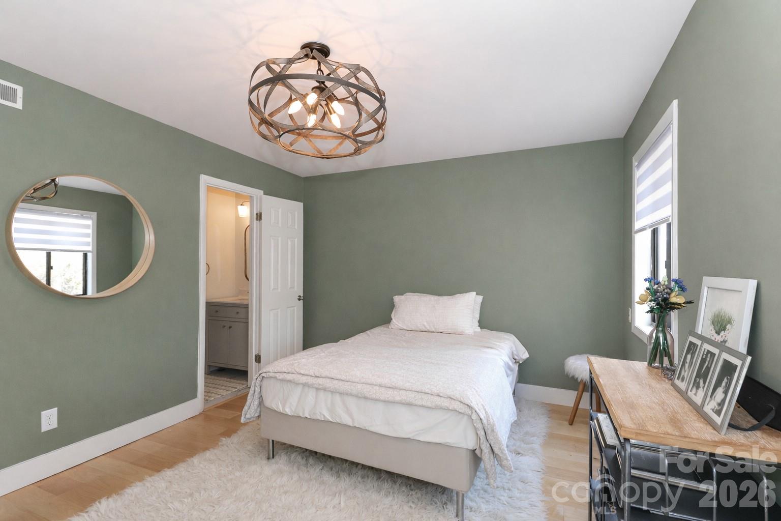 6622 Thermal Road Charlotte, NC 28211 - Photo 27 of 36 a bedroom with a bed and a chandelier
