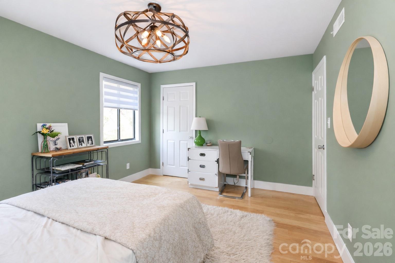 6622 Thermal Road Charlotte, NC 28211 - Photo 29 of 36 a bedroom with a bed and a chandelier
