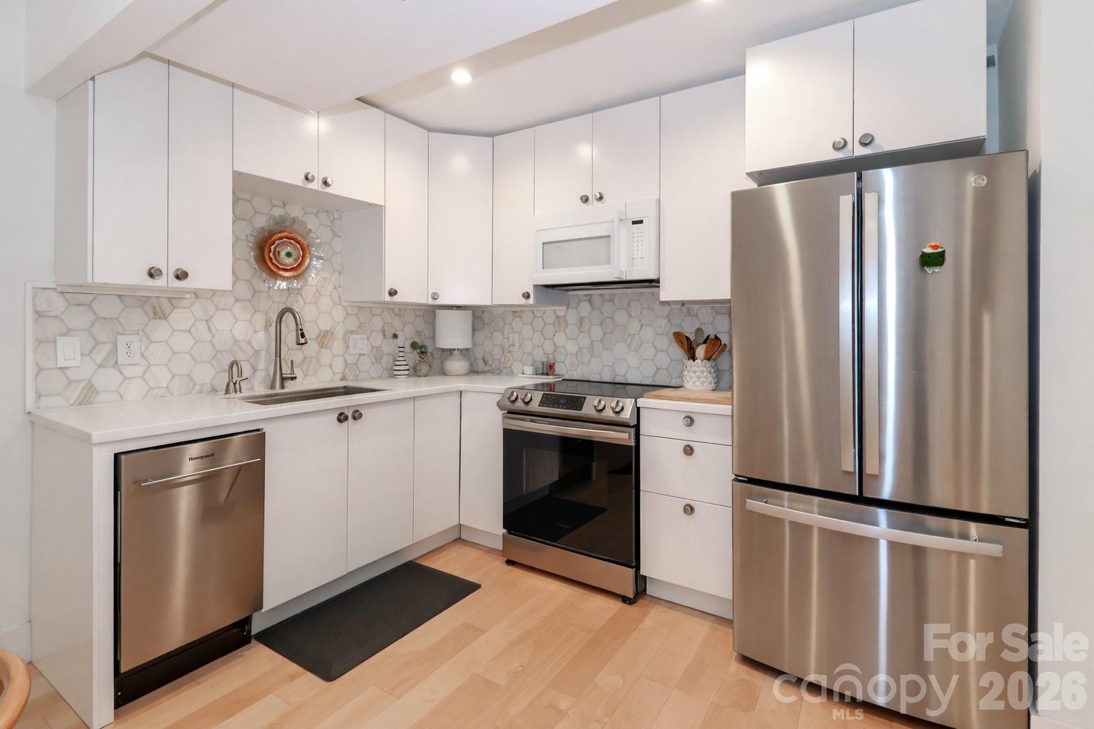 6622 Thermal Road Charlotte, NC 28211 - Photo 10 of 36 a kitchen with stainless steel appliances a refrigerator sink and cabinets