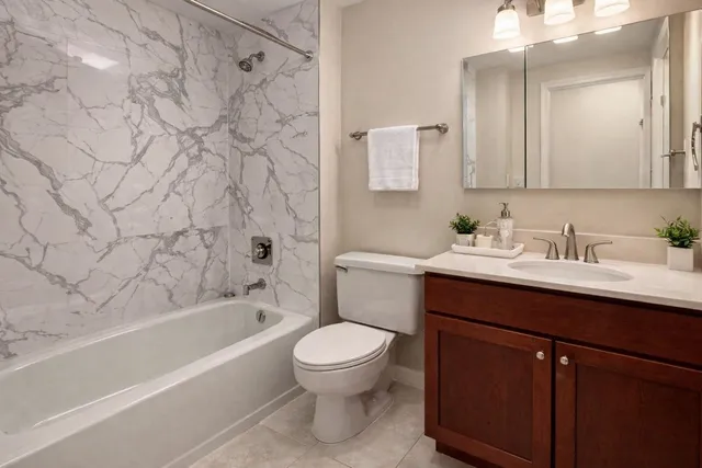 a bathroom with a sink toilet vanity and shower