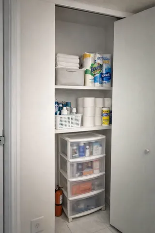 a shelf with cup and plates