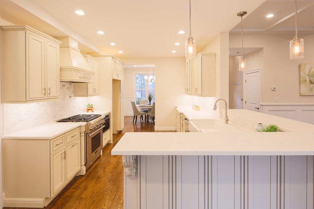 a kitchen with stainless steel appliances sink stove and cabinets