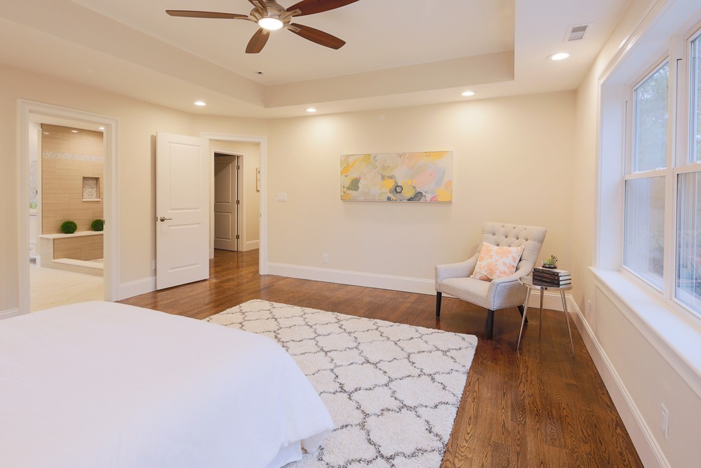 9 Holton Road Lexington, MA 02421 - Photo 11 of 27 a spacious bedroom with a bed and a chandelier