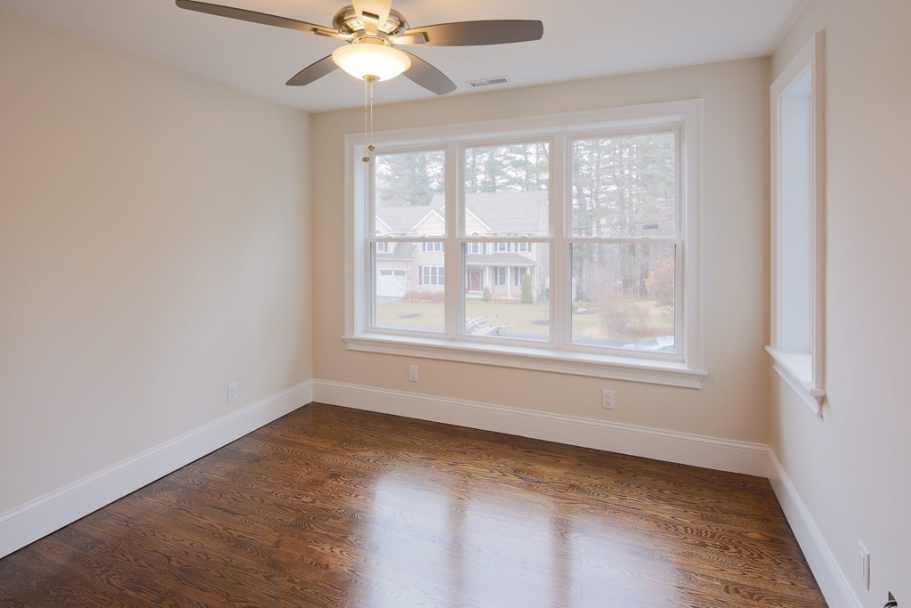 9 Holton Road Lexington, MA 02421 - Photo 16 of 27 an empty room with a window and a fan