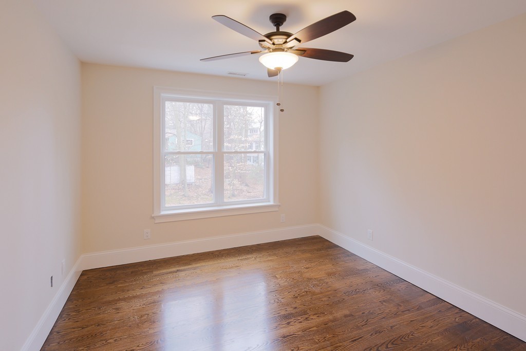 9 Holton Road Lexington, MA 02421 - Photo 17 of 27 an empty room with wooden floor fan and windows