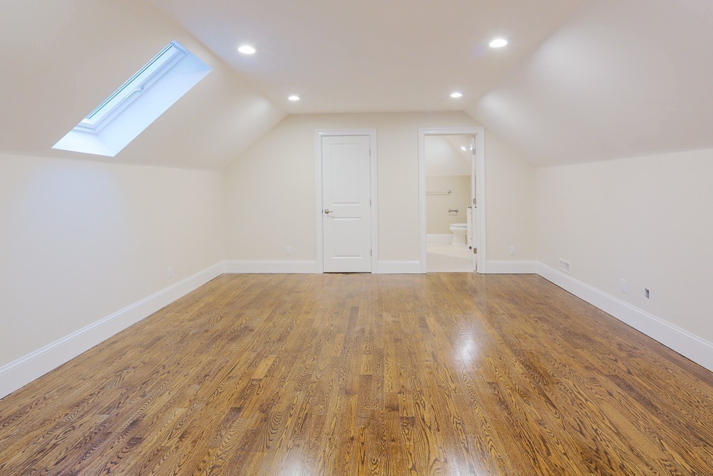 9 Holton Road Lexington, MA 02421 - Photo 18 of 27 an empty room with wooden floor and white walls