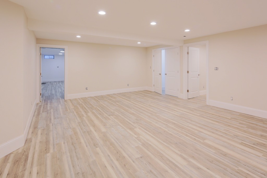 9 Holton Road Lexington, MA 02421 - Photo 19 of 27 an empty room with wooden floor and windows
