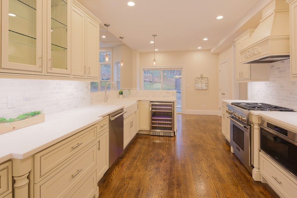 9 Holton Road Lexington, MA 02421 - Photo 2 of 27 a kitchen with stainless steel appliances a stove sink and cabinets