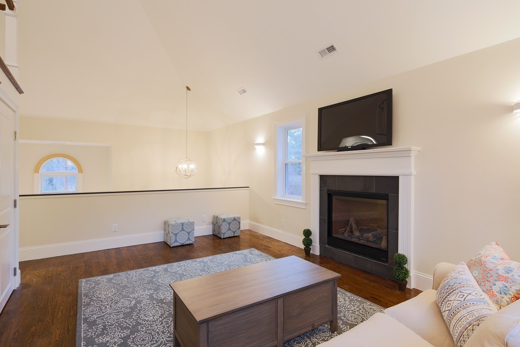9 Holton Road Lexington, MA 02421 - Photo 9 of 27 a living room with furniture and a fireplace