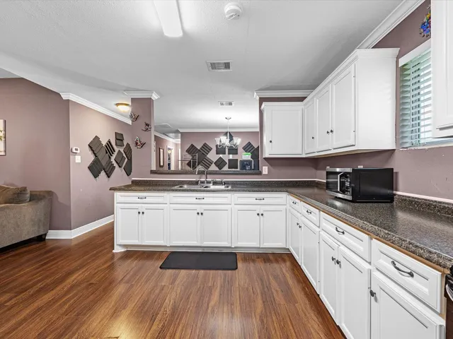 a kitchen with stainless steel appliances granite countertop a sink and cabinets