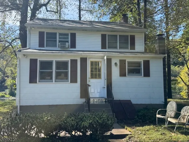 a view of a house with a yard and potted plants