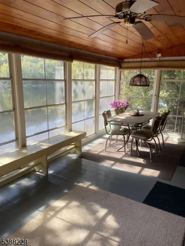 a dining room with furniture and a large window