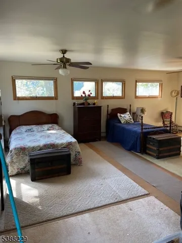 a bedroom with a bed and dresser with window