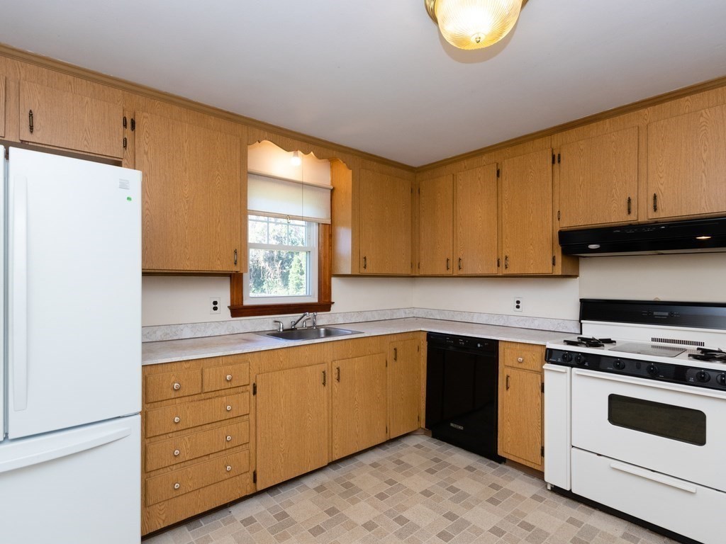 64 Judith Road Weymouth, MA 02191 - Photo 11 of 27 a kitchen with stainless steel appliances granite countertop a stove a sink and a refrigerator