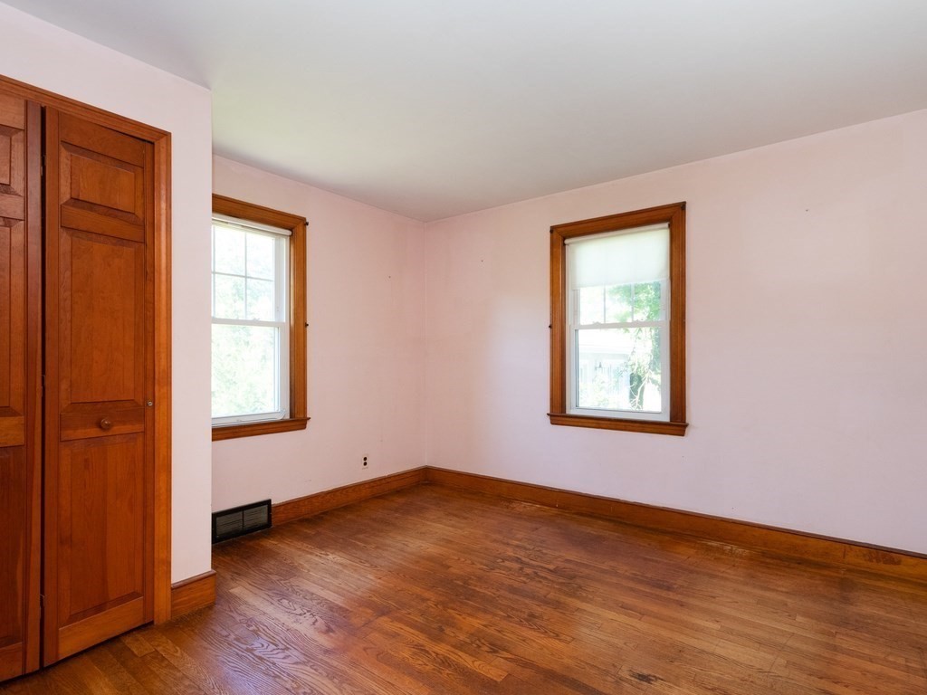 64 Judith Road Weymouth, MA 02191 - Photo 12 of 27 an empty room with wooden floor and windows