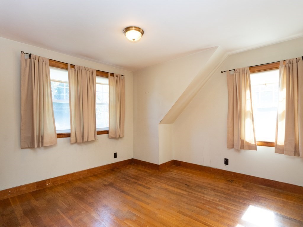 64 Judith Road Weymouth, MA 02191 - Photo 15 of 27 a view of an empty room with wooden floor and a window