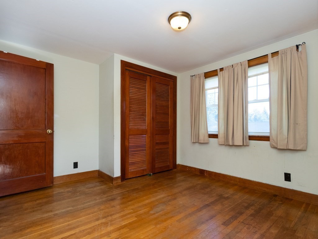 64 Judith Road Weymouth, MA 02191 - Photo 16 of 27 an empty room with wooden floor and windows