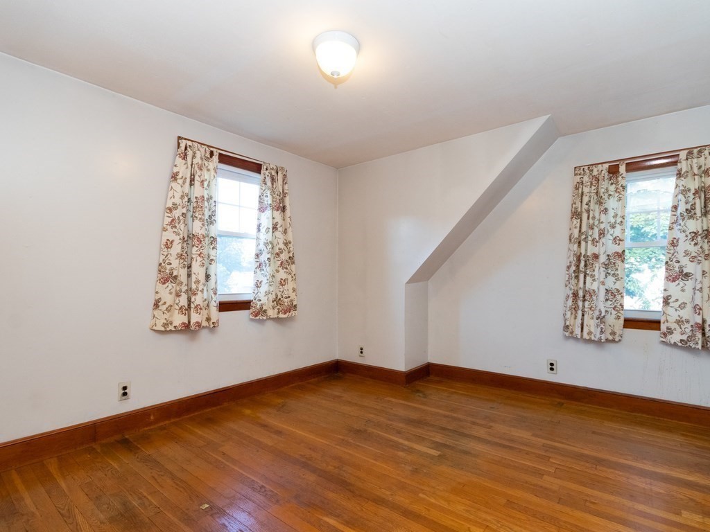 64 Judith Road Weymouth, MA 02191 - Photo 17 of 27 an empty room with wooden floor and windows