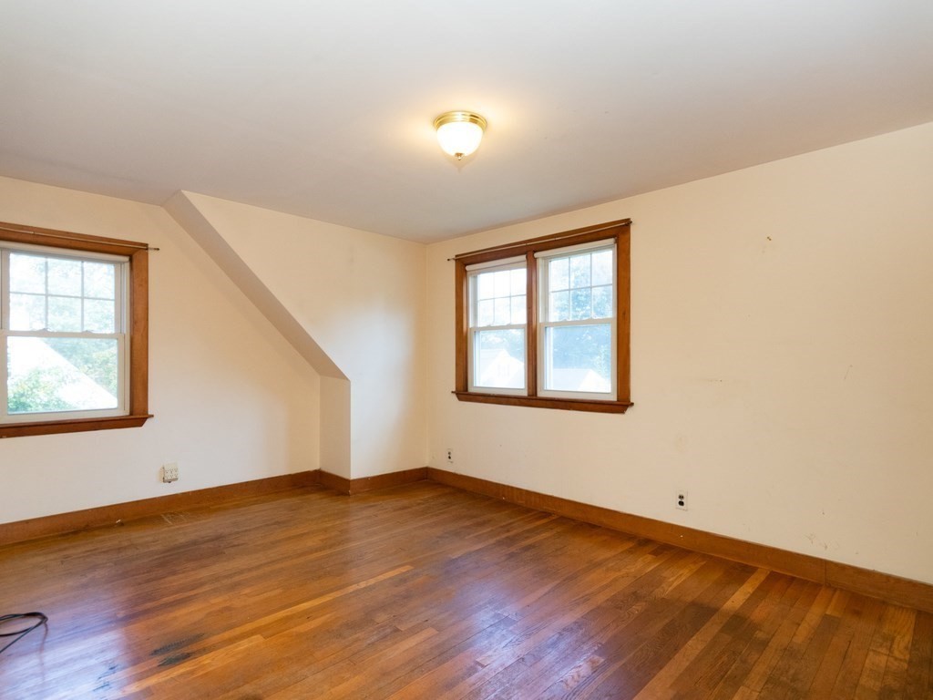 64 Judith Road Weymouth, MA 02191 - Photo 19 of 27 an empty room with wooden floor and windows