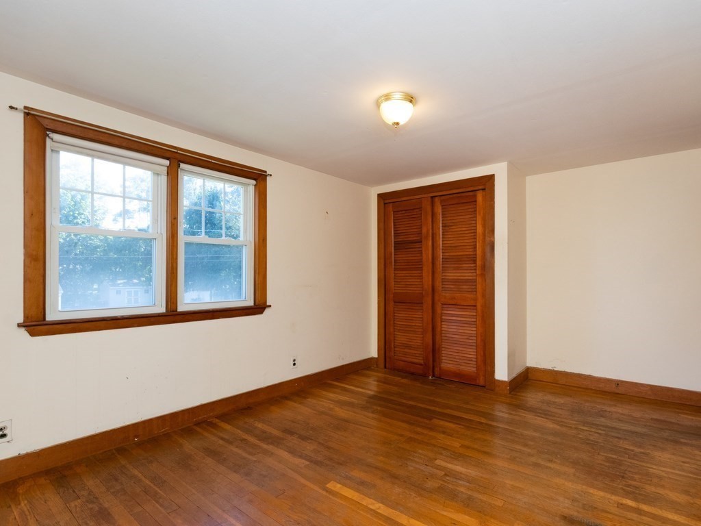 64 Judith Road Weymouth, MA 02191 - Photo 20 of 27 an empty room with wooden floor and windows