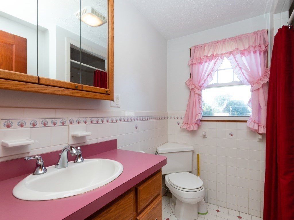 64 Judith Road Weymouth, MA 02191 - Photo 21 of 27 a bathroom with a sink a toilet and a mirror