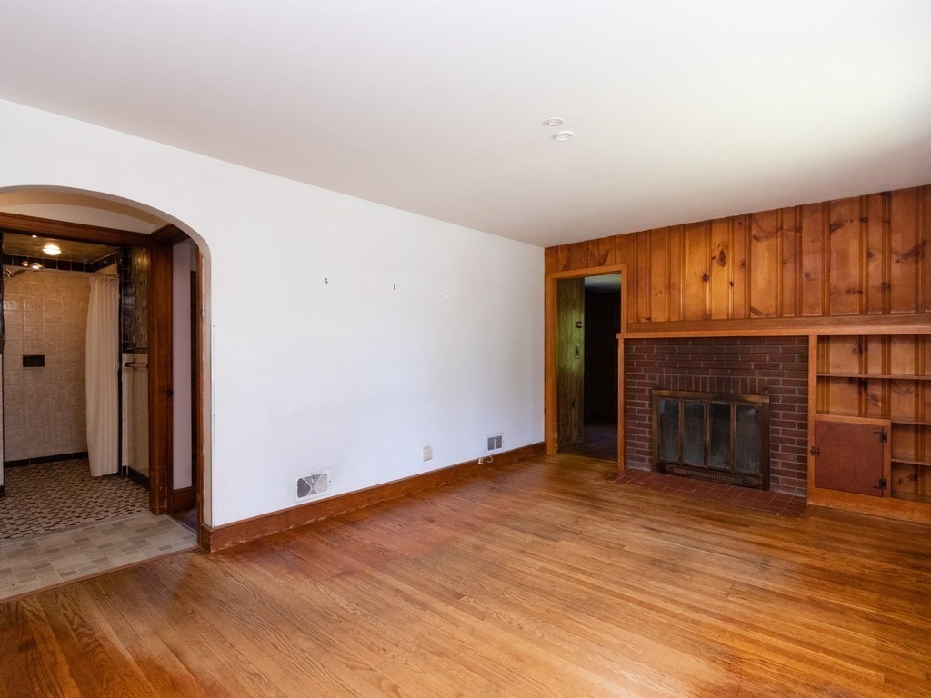 64 Judith Road Weymouth, MA 02191 - Photo 9 of 27 an empty room with wooden floor fireplace and windows