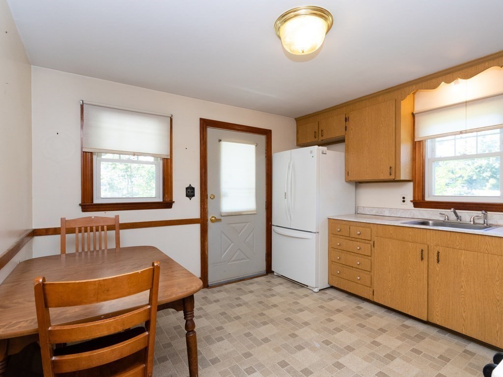 64 Judith Road Weymouth, MA 02191 - Photo 10 of 27 a kitchen with stainless steel appliances granite countertop a refrigerator and a stove top oven