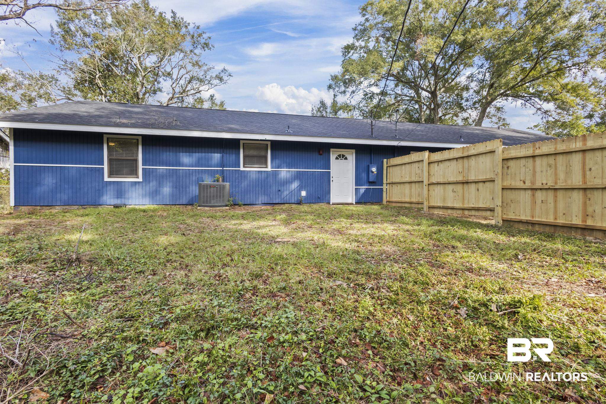 309 West Roosevelt Avenue Foley, AL 36535 - Photo 40 of 60 Rear view of property with central AC unit and a yard