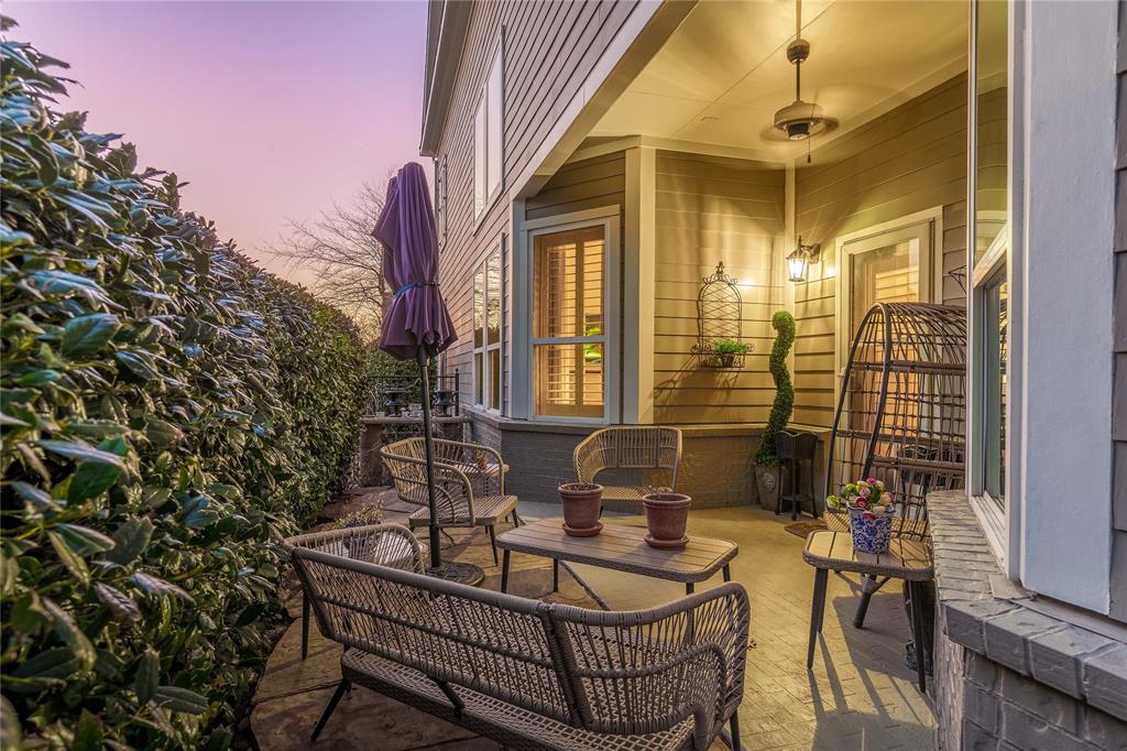 2500 Addison Street McKinney, TX 75071 - Photo 2 of 33 Side patio terrace at dusk. Hedge lined for privacy.