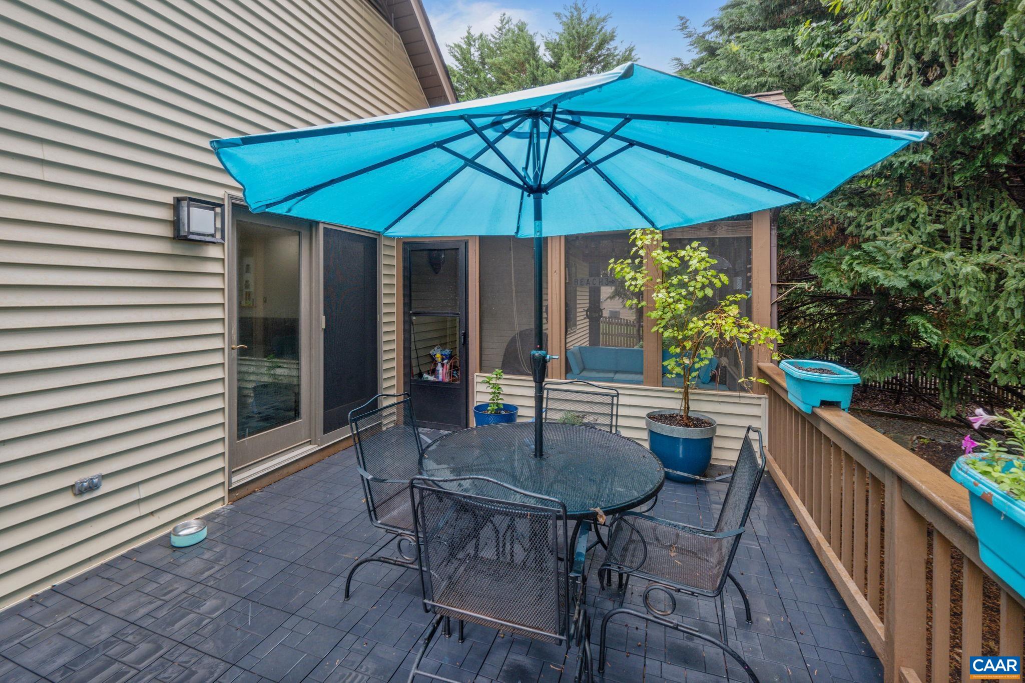 49 Amethyst Road Palmyra, VA 22963 - Photo 48 of 55 a patio with a table and chairs under an umbrella