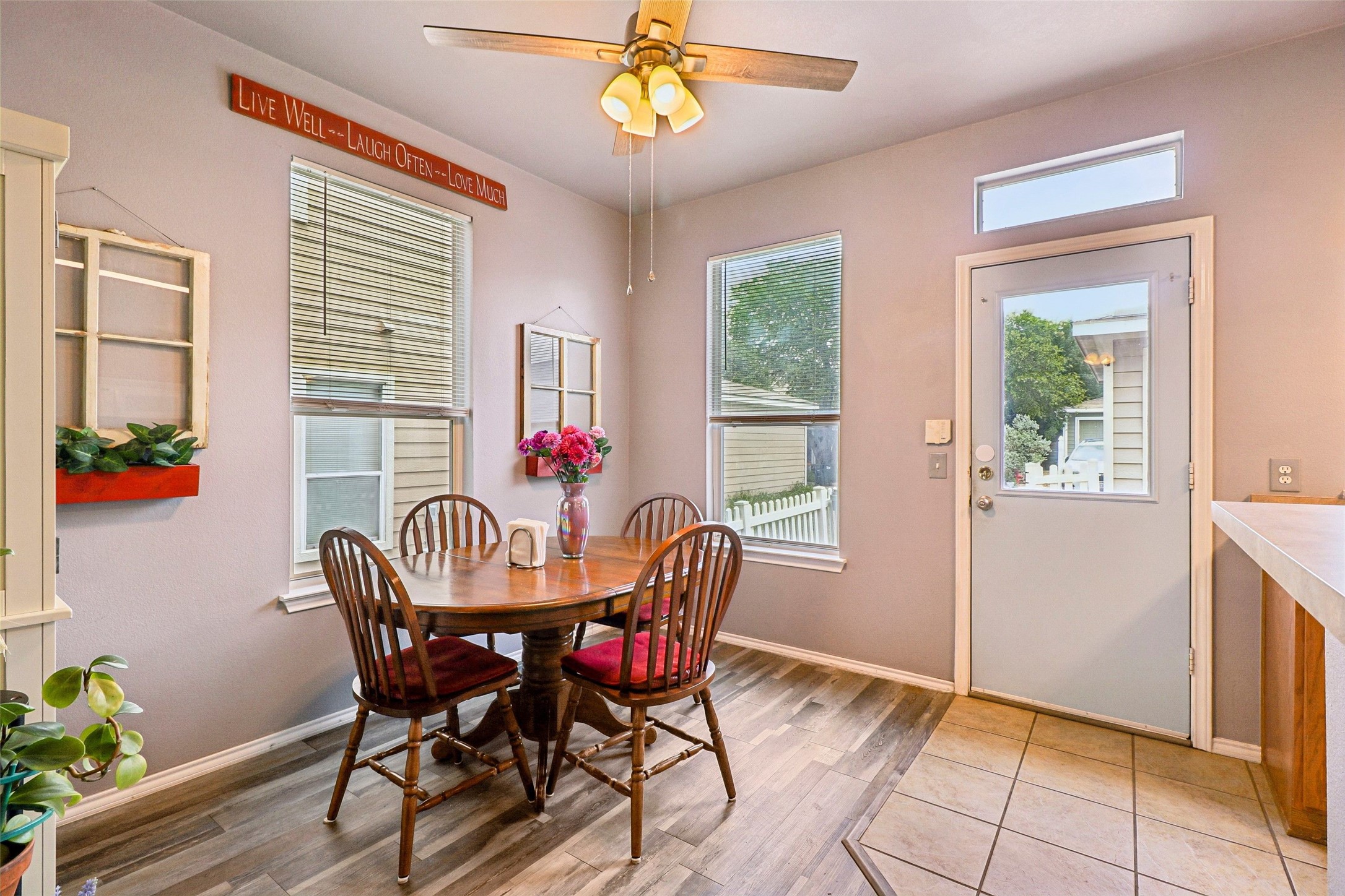 311 A Utterback Kyle, TX 78640 - Photo 5 of 40 Dining area featuring wood-finish flooring, a ceiling fan with integrated lighting, and multiple windows