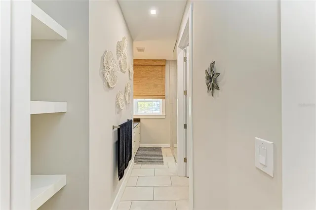 a kitchen with granite countertop a stove a sink and a refrigerator