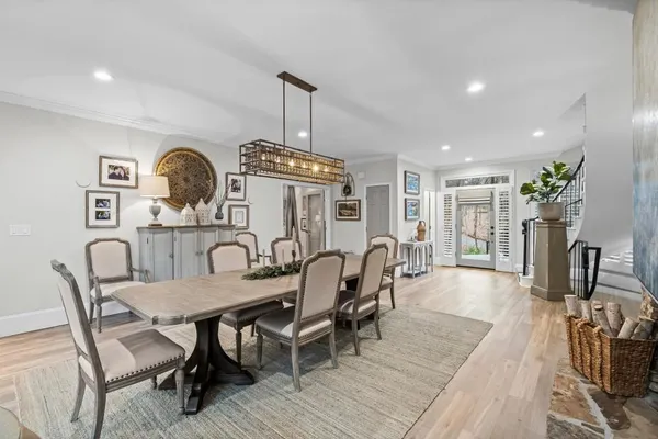a living room with furniture a flat screen tv and kitchen view