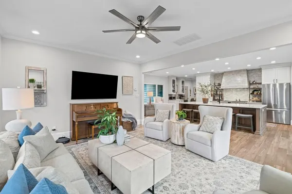 a large kitchen with stainless steel appliances a sink and a refrigerator