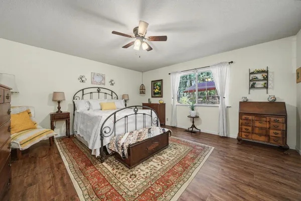 a bedroom with furniture and wooden floor