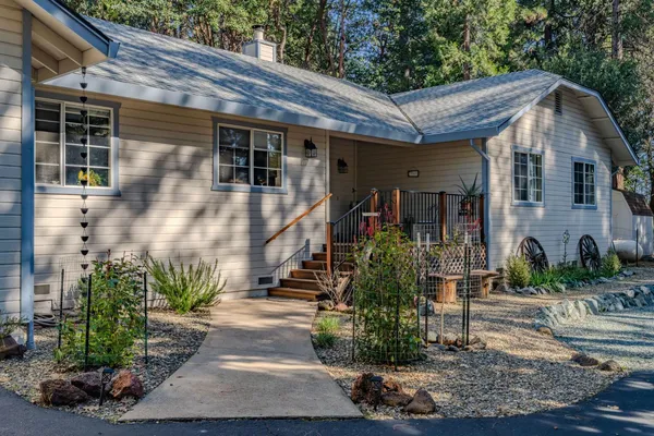 a front view of a house with garden